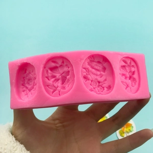 Pink silicone mold for butterfly flower cakes and soap with detailed floral patterns