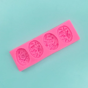 Macro shot of 4-cavity pink silicone mold featuring butterfly and flower patterns