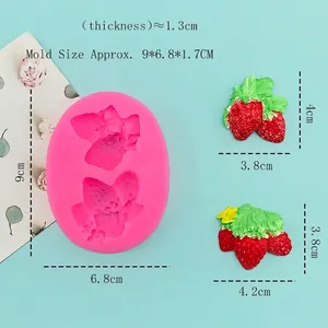 Pink silicone strawberry mold for chocolate fondant and candles on a light blue background