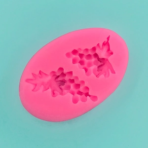 Detail of pink silicone mold with two grape bunch shapes for chocolate and candle making