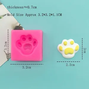 Pink silicone cat paw mold for DIY fondant and chocolate baking crafts on blue background
