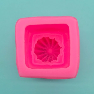 Detailed close-up of pink square silicone mold with fine sunburst texture for DIY crafts