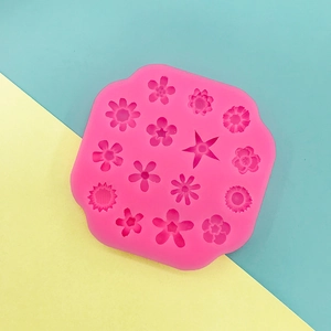 Top view of pink silicone mold with 15 various flower and star shapes for baking DIY