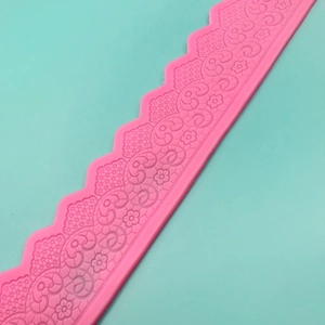 Detailed texture of pink silicone fondant mold with floral lace pattern for cake borders