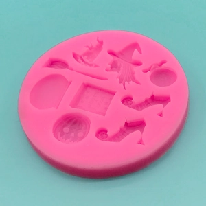 Pink silicone mold featuring Halloween elements like witch hats, pumpkins and broomsticks