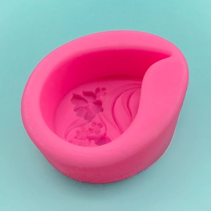Pink teardrop silicone mold with intricate 3D flower and butterfly patterns for crafts