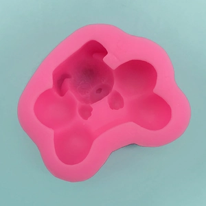 Detailed top view of pink silicone DIY dog mold for baking and soap making on blue background