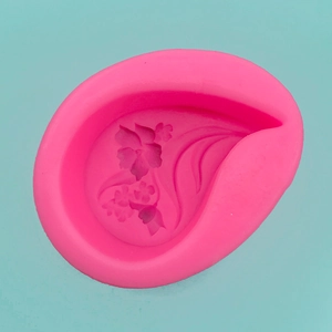 Detail of pink silicone mold featuring intricate 3D floral relief for cake decorating