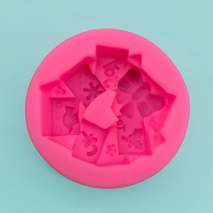 Macro detail of round silicone mold with 3D bow, bird, and floral patterns for soap making