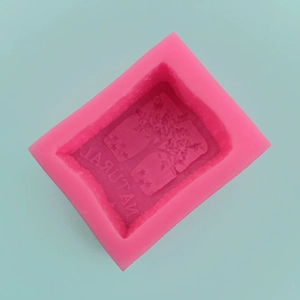 Close-up of pink rectangular silicone mold with 3D floral pattern and Natural text