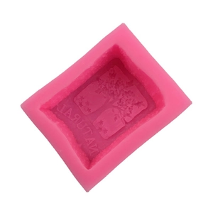 Pink silicone mold featuring 3D natural tree patterns and mirror NATURAL text for soap making