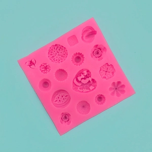Detail of rose and heart shaped cavities in a pink silicone DIY baking mold
