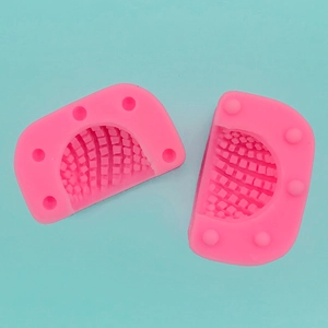 Detailed view of pink silicone walnut mold with fine grid texture for DIY baking