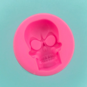 Macro shot of pink silicone skull mold for DIY Halloween chocolate and fondant cake crafts