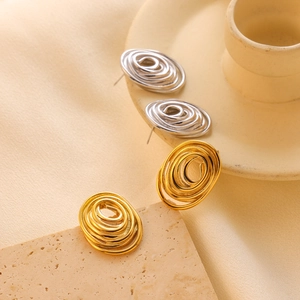 Modern gold and silver spiral oval stud earrings with elegant brushed metal texture