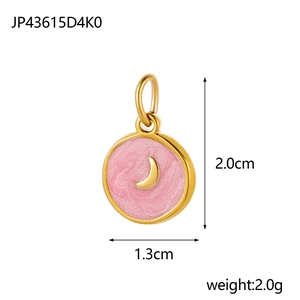 Macro view of gold-plated star and moon pendant with pink enamel and size measurements