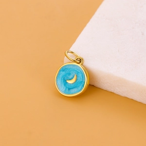 Detailed view of sky blue enamel moon pendant in polished gold for DIY jewelry