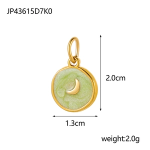 Detail view of a 13mm gold round charm with a crescent moon over green pearlescent inlay