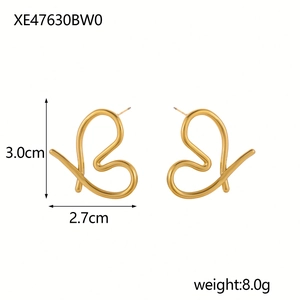 Detail view of gold abstract heart-shaped stud earrings with dimensions and weight info