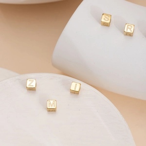 Minimalist gold cube charms with engraved capital letters for DIY jewelry making