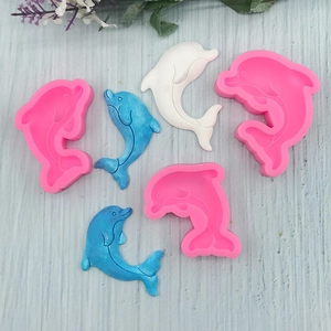 Pink dolphin silicone cake mold set with blue and white finished fondant decorations