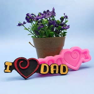 Macro shot of pink silicone DIY cake mold featuring I Love Dad heart-shaped design
