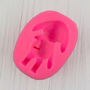 Detailed top view of pink silicone mold featuring a 3D girl doll cavity for DIY clay crafting
