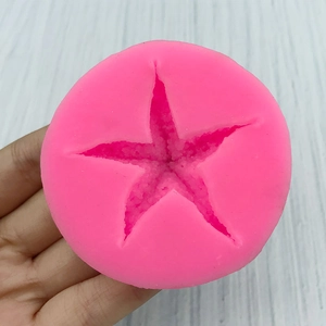 Pink starfish silicone mold for fondant baking and DIY crafts shown on round base