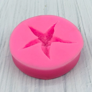 Pink starfish silicone mold for DIY fondant baking and plaster crafts in a round base
