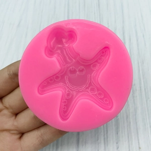 Pink silicone mold featuring a cartoon starfish with a chef hat for cake decorating