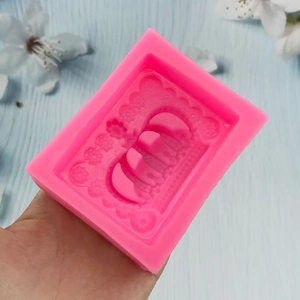 Pink silicone crown mold for handmade soap and chocolate crafts on blue background