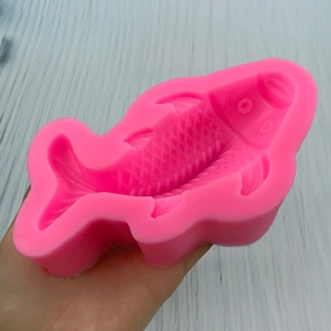 Pink silicone fish mold for cake decorating showing detailed scale and fin textures