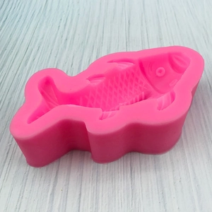 Pink silicone mold shaped like a carp fish for cake decorating and fondant crafts