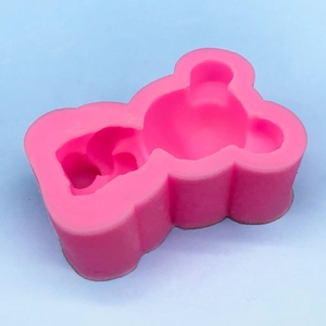 Pink Hello Kitty style silicone mold for DIY chocolate and cake decoration on blue background