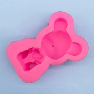 Detailed view of pink silicone mold with 3D teddy bear design for cake decorating