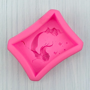 Macro shot of rose red silicone mold with ocean wave texture for soap making