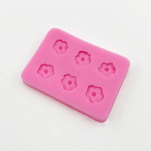 Detail of pink silicone mold with 6 daisy cavities for DIY baking and resin crafts
