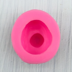 Top view of pink 3D duck silicone mold for soap and fondant on a wood table