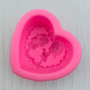 Detail view of pink silicone mold with 3D couple relief and rose wreath decoration