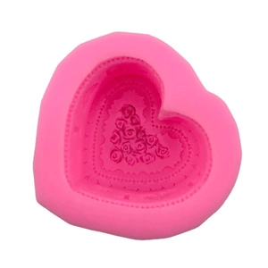Pink heart-shaped silicone mold with detailed rose bouquet texture for baking and DIY