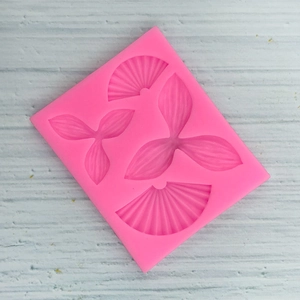 Macro detail of pink silicone mold with fan and leaf textures for cake decorating