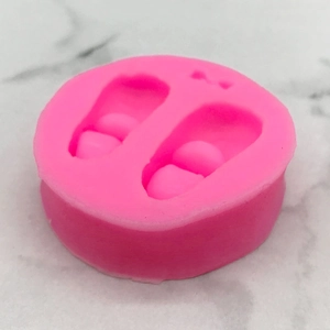Pink silicone mold featuring two cute baby shoe shapes for DIY fondant and cake baking crafts