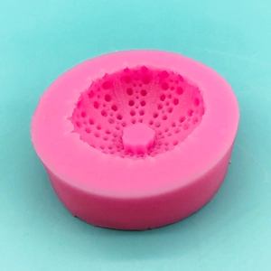Macro shot of pink silicone ocean mold interior with detailed geometric dot patterns
