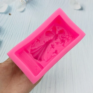Bright pink silicone mold with 3D angel girl and floral relief design for baking