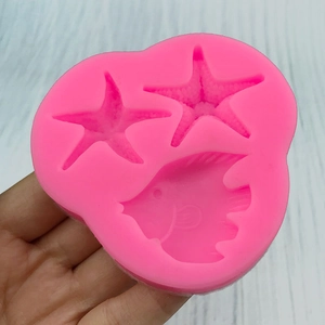 Pink silicone mold featuring starfish and fish shapes for DIY cake decorating and crafts