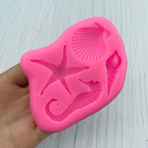 Pink silicone mold featuring seahorse, starfish, scallop, and seashell for fondant and DIY crafts
