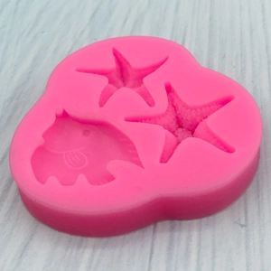 Pink silicone mold with starfish and seashell shapes for DIY cake decorating and crafts