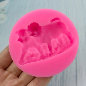Pink silicone mold for dog-shaped fondant decorations and chocolate crafts shown in hand