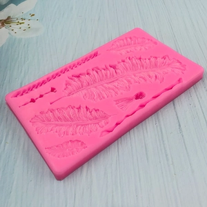 Large pink silicone mold with detailed feather textures for fondant cake decoration