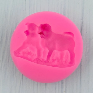 Top view of a pink silicone mold featuring two detailed bulldog silhouettes for baking